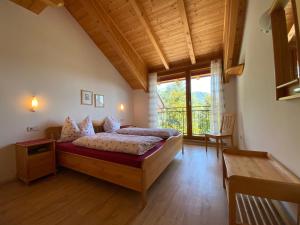 a bedroom with a bed and a large window at Gästehaus Anna in Caldaro