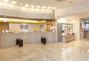 a large lobby with a counter in a store at Onomichi Kokusai Hotel in Onomichi
