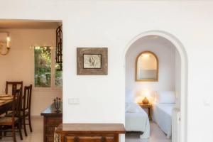 ein Schlafzimmer mit Bett und ein Esszimmer in der Unterkunft Villa Cecylia in Es Canutells