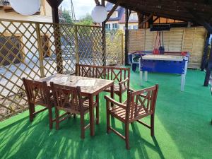 a patio with a table and chairs and a ping pong table and a pool at Apartament Kudowa Zdrój - Słone 60m2 in Kudowa-Zdrój