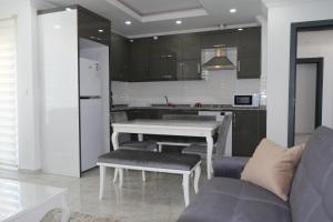 a kitchen with a white table and a couch at YILDIZ APART in Demre