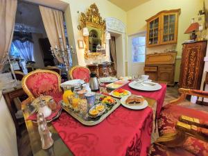 a table with plates of food on top of it at Rezidence Zámeček - Boutique Hotel in Františkovy Lázně