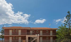 a building with a blue sky and clouds at eleni studios in Vlachata