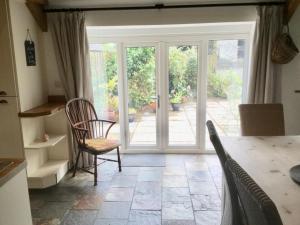 a kitchen with a door leading to a patio at Cuckoo Barn at Penygaer farm near the Brecon Beacons in Llandovery