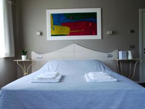 a bedroom with a blue bed with two towels on it at Residenza Case Pacifici in Ascoli Piceno