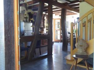 a kitchen with a table and a refrigerator in a room at La Pomme de Pin in Raedersdorf