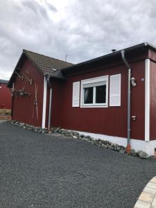 a red building with a window on the side of it at Ferienhaus Schädertalblick in Wolfshagen