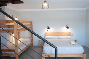 a bedroom with a bed and a staircase at Apartamentos de la Parte Antigua de Cáceres in Cáceres