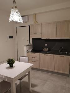 a kitchen with a white table and a white counter top at APPARTAMENTS SAN FRANCESCO in Castelfiorentino +17 photos