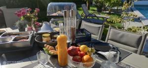 a table with a tray of fruit and juice on it at O’Berges D’Astacus in Beloeil