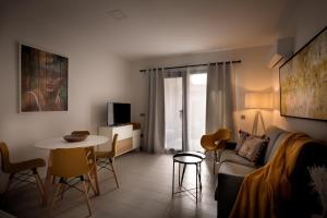 a living room with a couch and a table at Apartamentos Turísticos Huerto El Horno in Torremenga