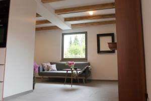 a living room with a couch and a table with flowers at dresden-ferien haus in Dresden