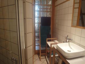 a bathroom with a sink and a table and a mirror at Le jardin des remparts in Colmar +20 photos