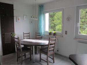 comedor con mesa, sillas y ventana en Ferienwohnung Brasil en Schonach