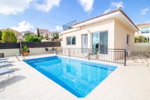 a swimming pool in the backyard of a house at Villa Anna in Tala