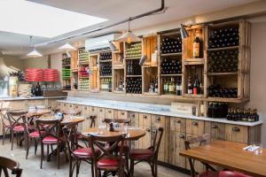 a restaurant with wooden tables and chairs and wine bottles at The white home near Kensington high st in London