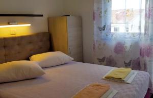 Postel nebo postele na pokoji v ubytování Apartmani Kurjaković - Punat