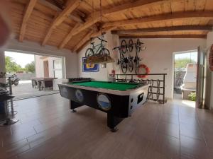 a living room with a pool table in the middle at AS Apartments Peroj in Peroj