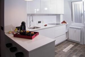 a white kitchen with a sink and a counter at El Rincón de Eva in Salamanca