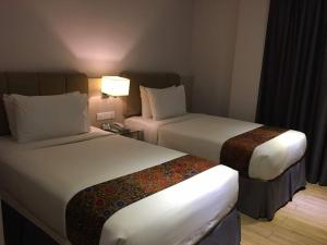 Postel nebo postele na pokoji v ubytování NU Hotel @ KL Sentral