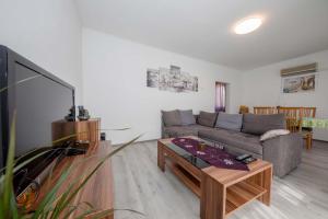 a living room with a couch and a table at House Stojakovic in Banjol