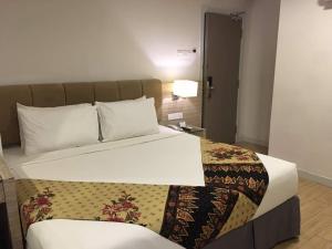 Postel nebo postele na pokoji v ubytování NU Hotel @ KL Sentral