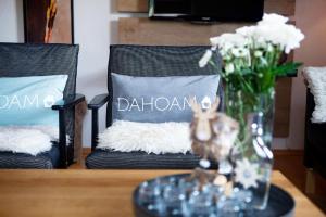 a table with two chairs and a vase with flowers at Ferienhaus Kollinger in Kaprun