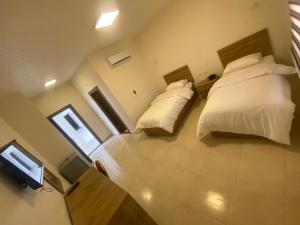 an overhead view of a bedroom with two beds and a television at Al-Mujeb in Kerak