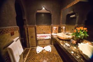 a bathroom with two sinks and a large mirror at Riad Mimouna in Essaouira