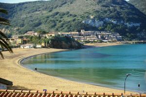 a person walking on a beach next to the water at B&B CASA GIOVANNA in Campese