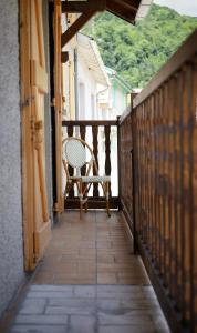 un balcon avec une chaise assise sur une terrasse couverte dans l'établissement Appartement VILLA PAULA Ax-les-Thermes, à Ax-les-Thermes