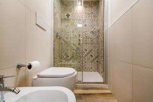 a bathroom with a shower with a toilet and a sink at Dimora Cavour in Polignano a Mare