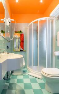 a bathroom with a shower and a toilet and a sink at Hotel K2 Bellaria in Bellaria-Igea Marina