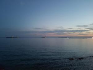 a view of a large body of water at dusk at Philos - Appartements & Rooms in Taranto