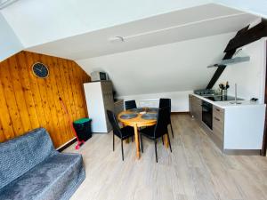 a kitchen and dining room with a table and chairs at résidence les pâquerettes N 4 in Le Mont-Dore