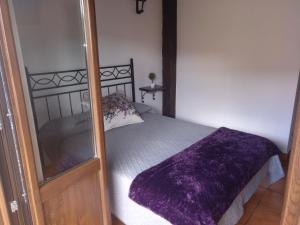 
a bedroom with a bed and a dresser at HOTEL RURAL SIERRA DE FRANCIA in Sotoserrano
