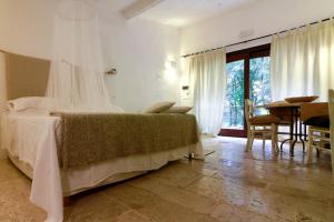 Un pat sau paturi într-o cameră la Masseria Iazzo Scagno