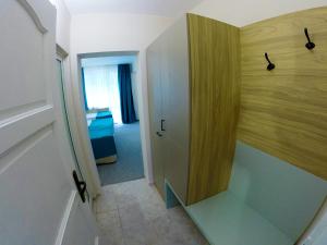 a door is open to a bathroom with a sink at Hotel Lotos in Kiten