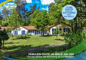 a house in a yard with a sign that reads familiar surf in yard am at Familien-Suite-im-Wald-am-See in Bork