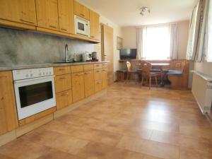 a large kitchen with wooden cabinets and a table at Ferienwohnung Bluemelhube Wohnung Anja in Vordernberg