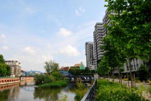 a river in a city with buildings and a bridge at TWO TOWERS Old Town Apartments-City center-by the river-observation terrance on the roof-free parking in Wrocław +10 photos
