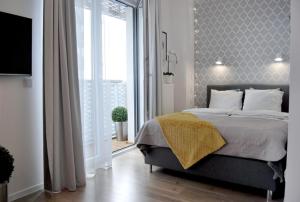 a bedroom with a bed and a large window at TWO TOWERS Old Town Apartments-City center-by the river-observation terrance on the roof-free parking in Wrocław