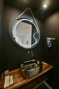 a bathroom sink with a mirror above it at Hydra Icons in Hydra