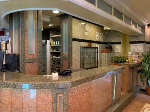 a lobby with a large counter in a store at California Hotel in Sofia