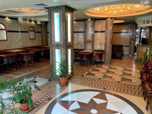 a restaurant with a lobby with tables and chairs at California Hotel in Sofia