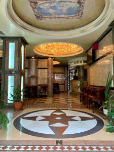 a lobby of a hotel with a large ceiling at California Hotel in Sofia