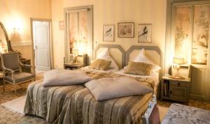 a bedroom with a large bed with pillows on it at " Chimay B & B " - ptits déj gourmands proposés in Chimay +71 photos