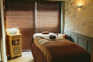 a bedroom with a bed with a bowl on it at Feversham Arms Hotel & Verbena Spa in Helmsley
