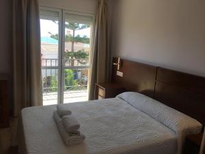 Ένα ή περισσότερα κρεβάτια σε δωμάτιο στο Hostal - Restaurante Playa Azul
