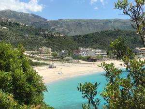 a view of a beach with mountains in the background at Villa Calliope in Himare